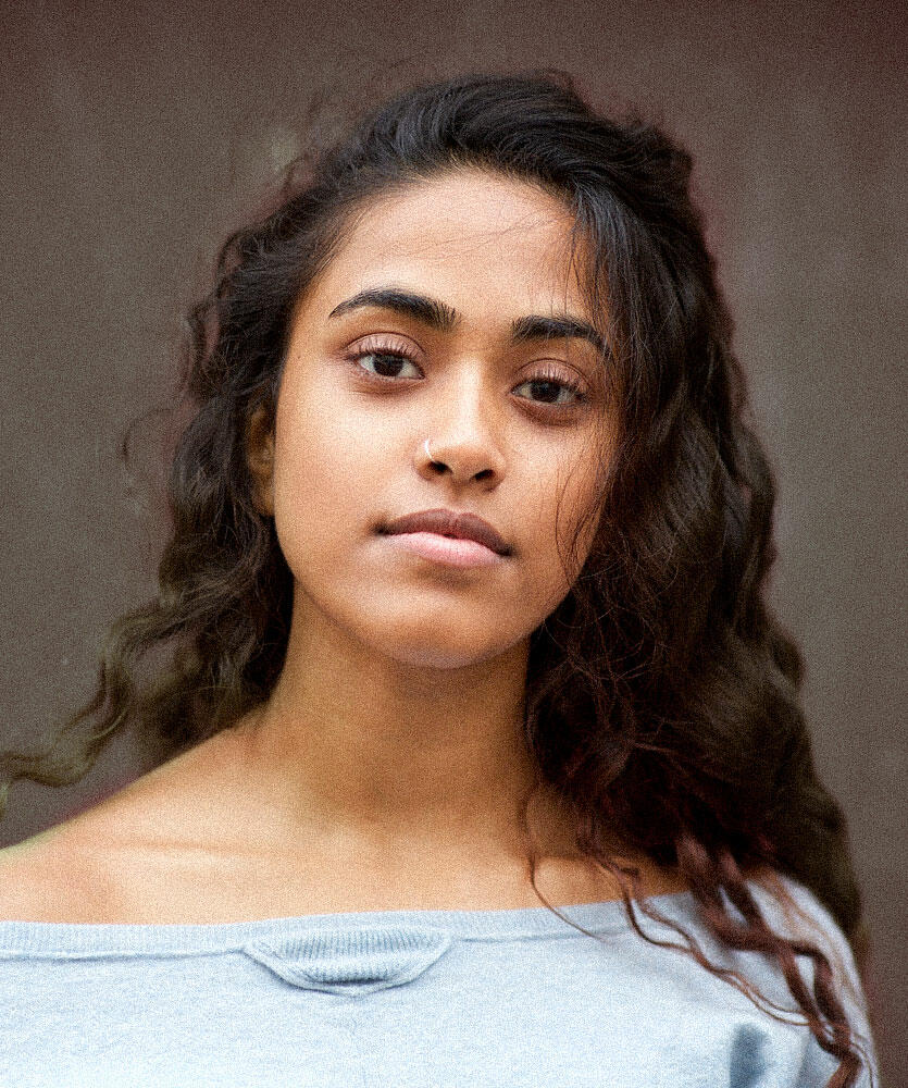 A young woman smiles at the camera